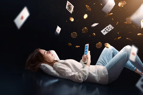 A young woman relaxing with her phone while dynamic casino elements float around her, illustrating the smooth mobile experience offered by the 2777BED app.